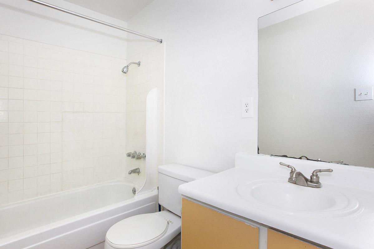 a white tub sitting next to a sink