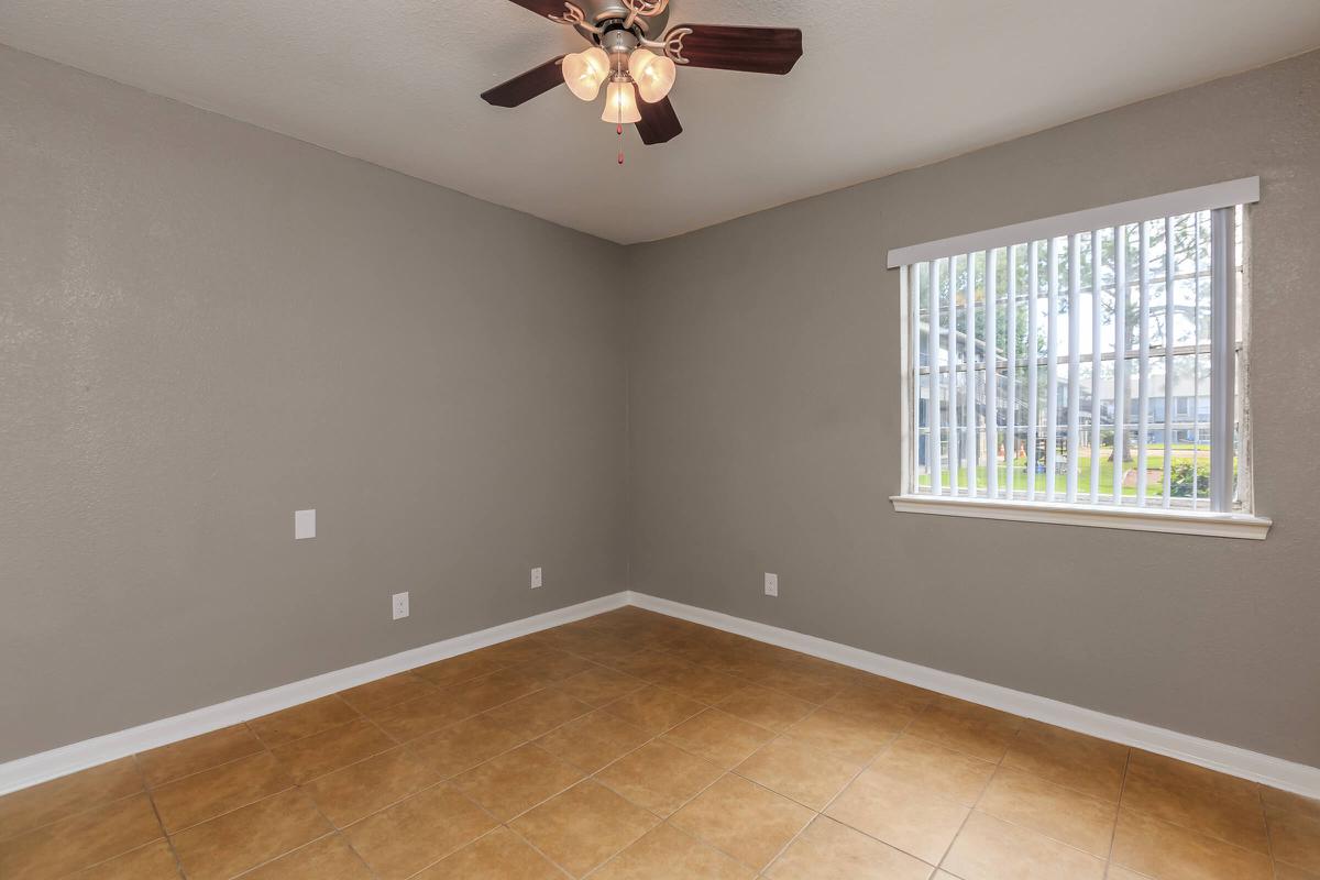 a large empty room with a sink and a window