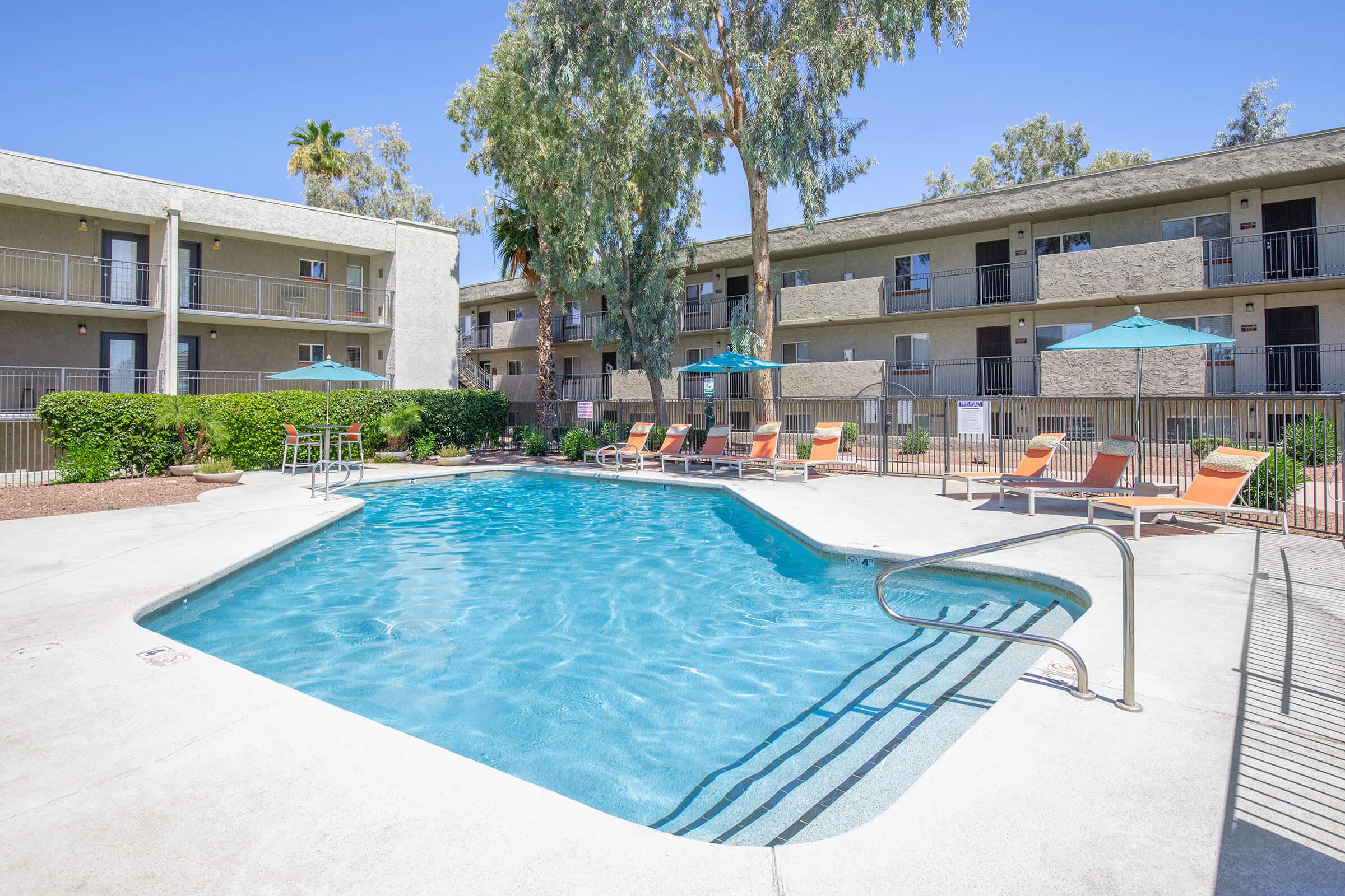 a house with a pool in front of a building