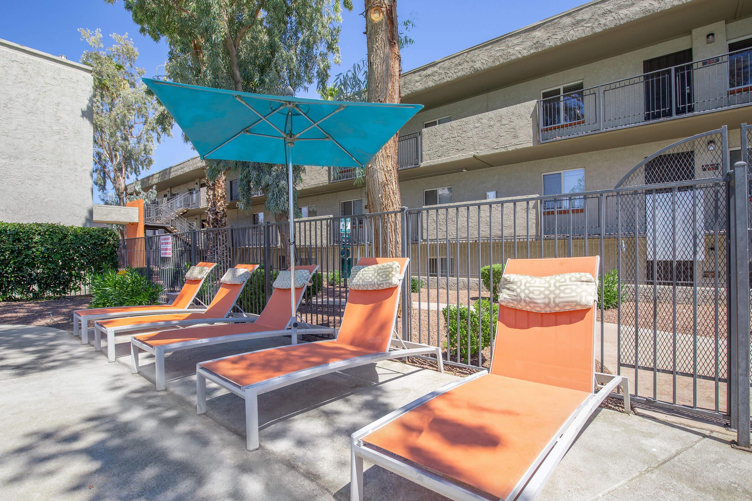 an orange bench in front of a building