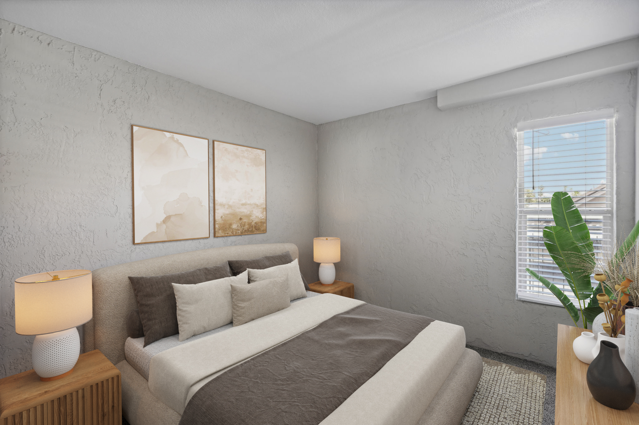 A modern bedroom featuring a neutral color palette. The room has a cozy bed with gray and beige bedding, two bedside tables with lamps, and artwork hanging on the wall. A large window allows natural light to fill the space, and a leafy plant adds a touch of greenery. The walls have a textured finish.