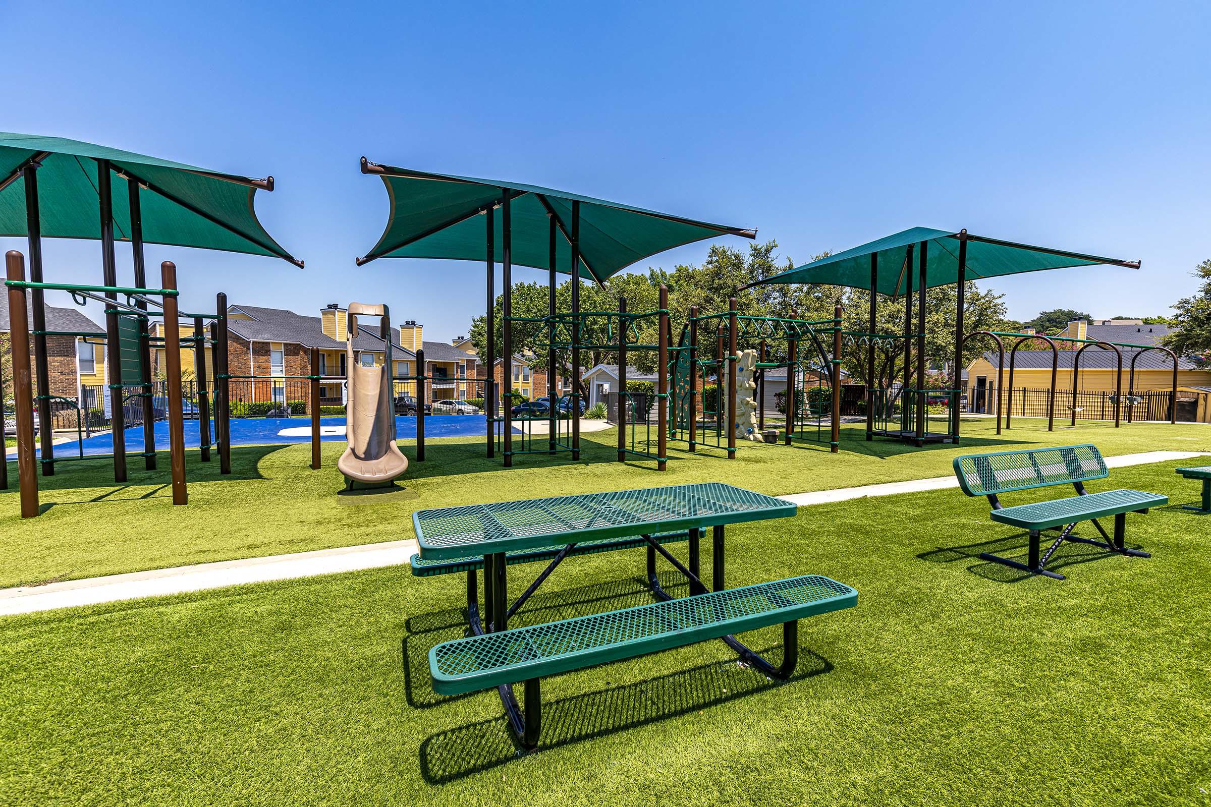 a group of lawn chairs sitting on top of a picnic table