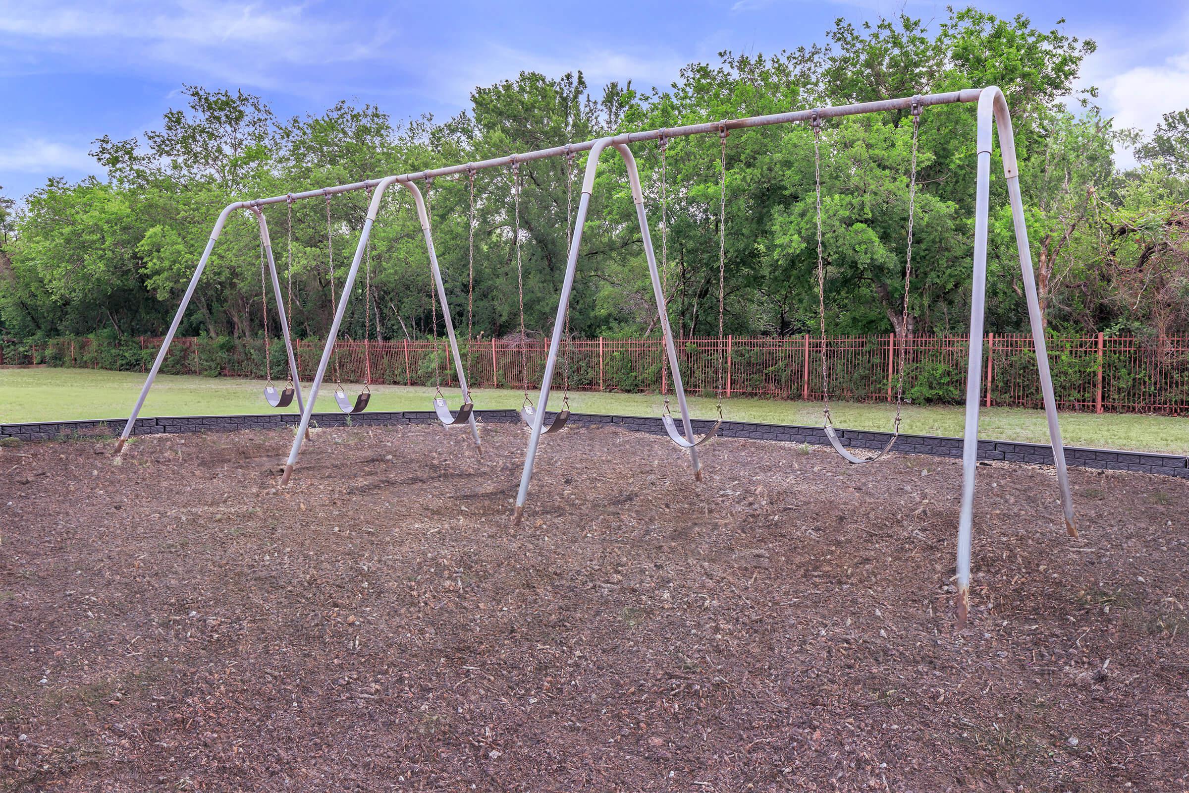 a swing set in the middle of a field