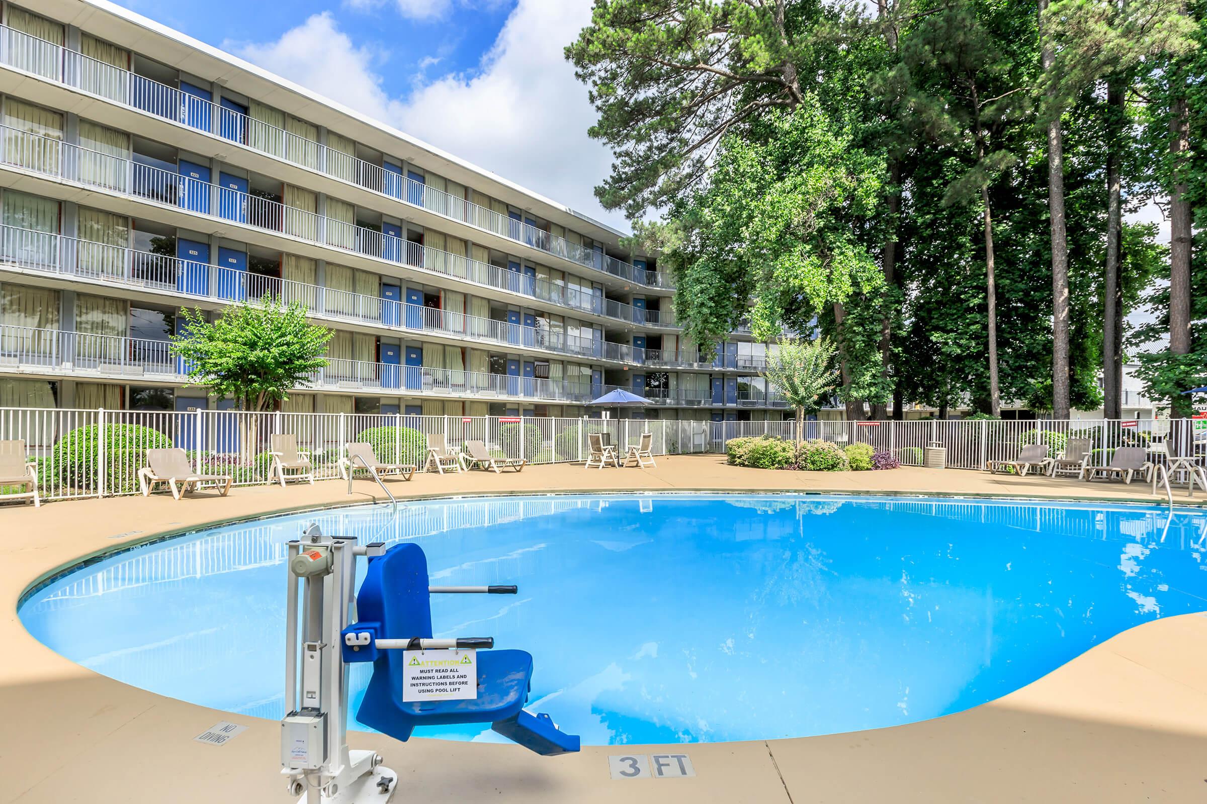 a blue pool of water in front of a building