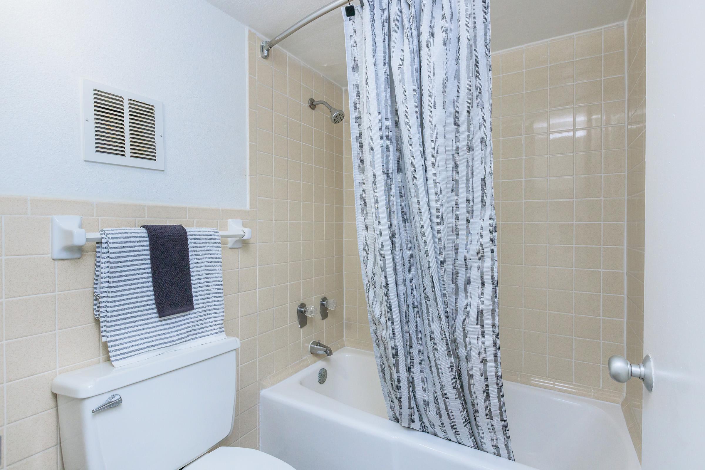 a shower curtain next to a sink