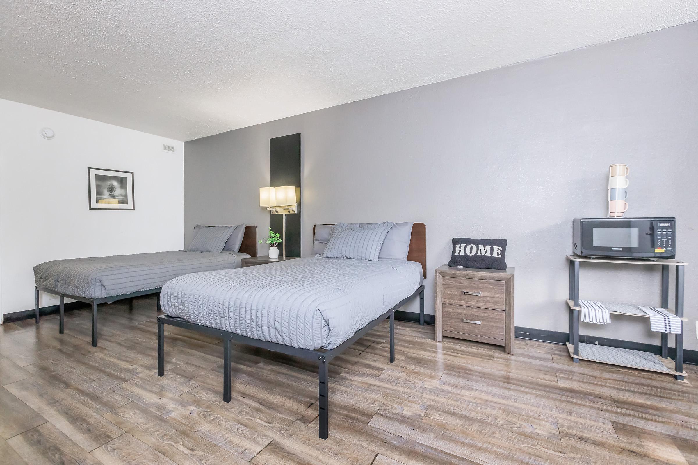 a bedroom with a bed and desk in a room