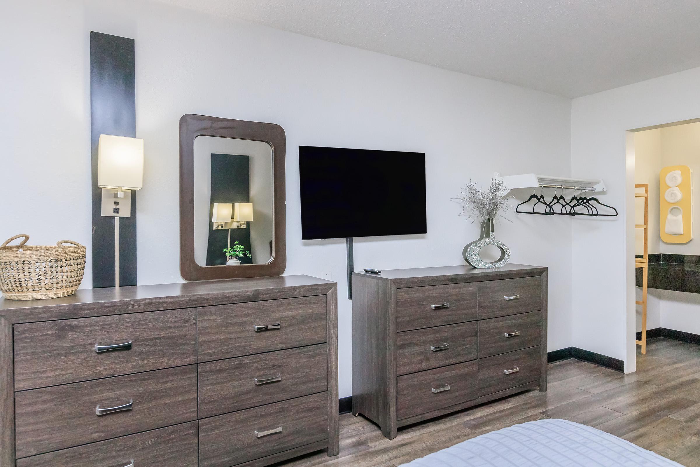 a bedroom with a bed and desk in a room