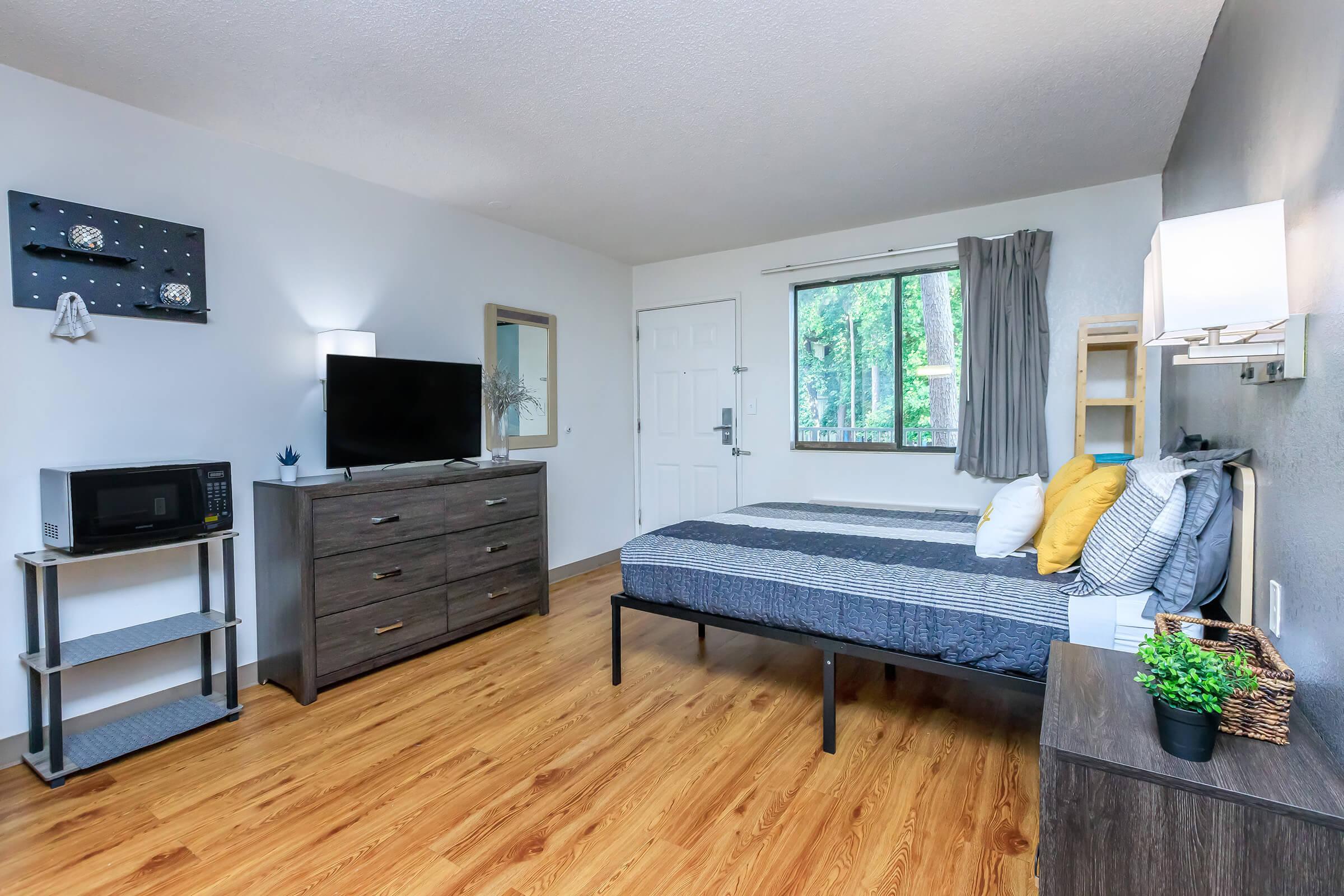 a living room filled with furniture and a flat screen tv