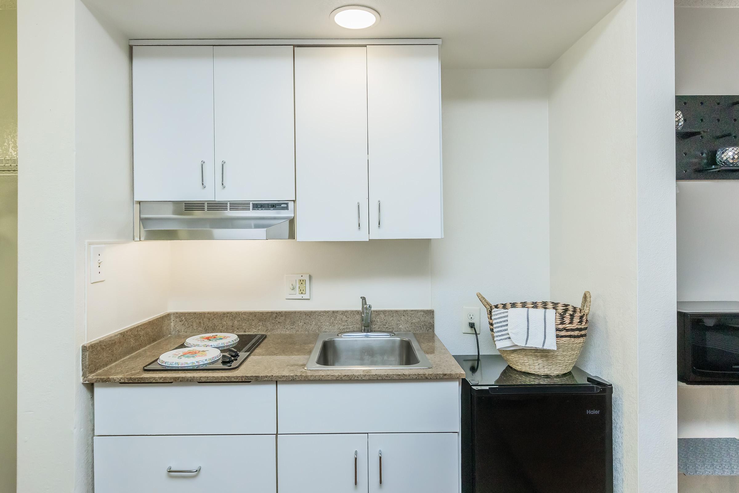 a kitchen with a stove top oven sitting inside of a refrigerator