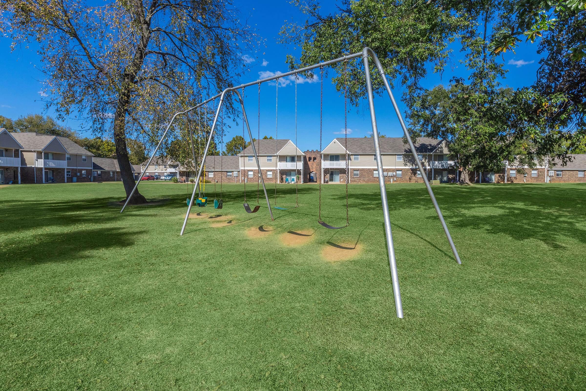 a swing set in a grassy field