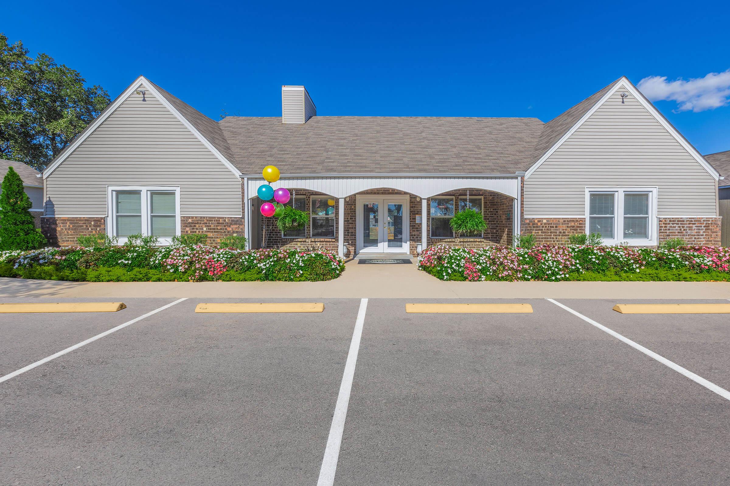 an empty parking lot in front of a house