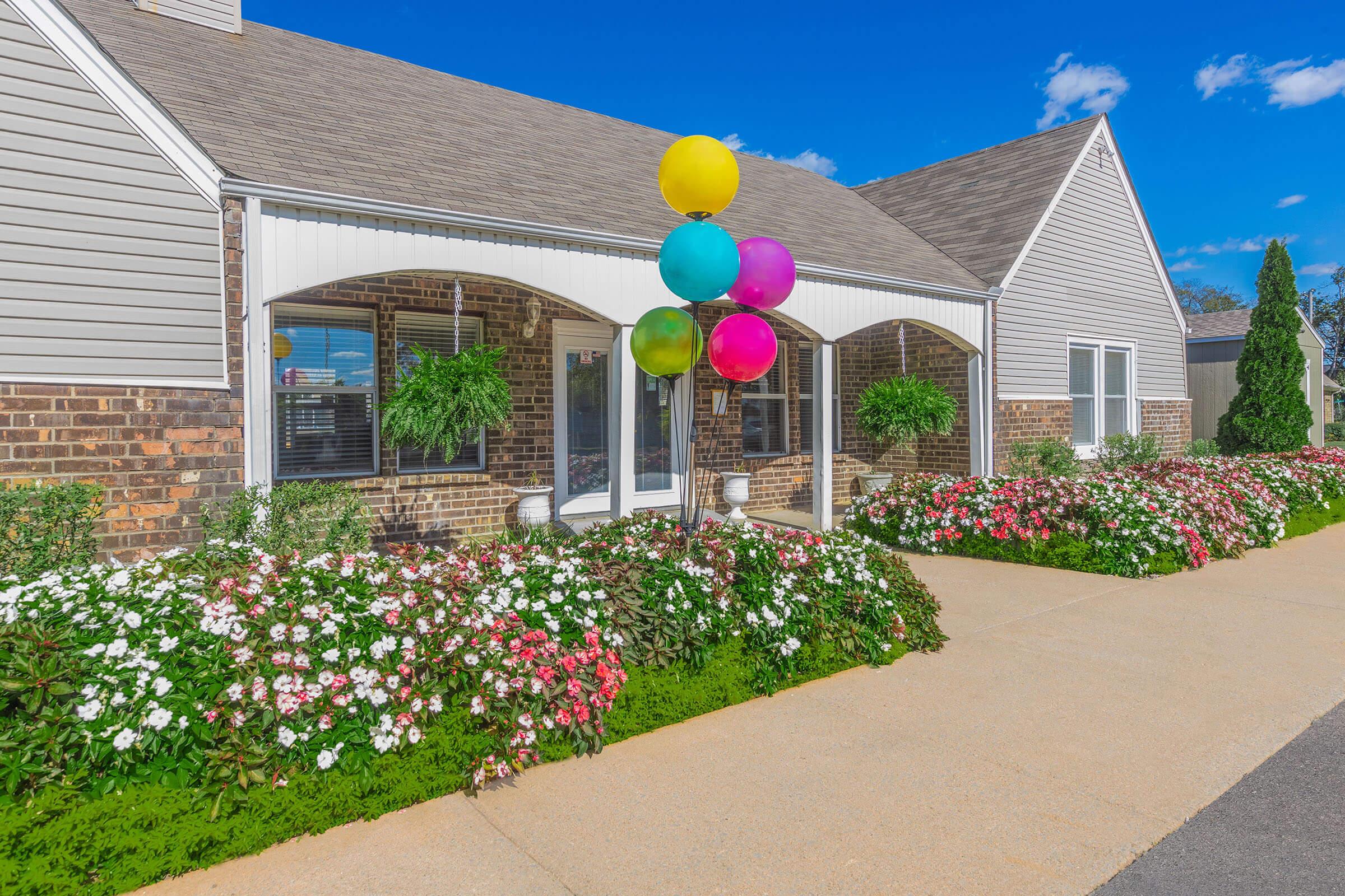 a close up of a flower garden in front of a building