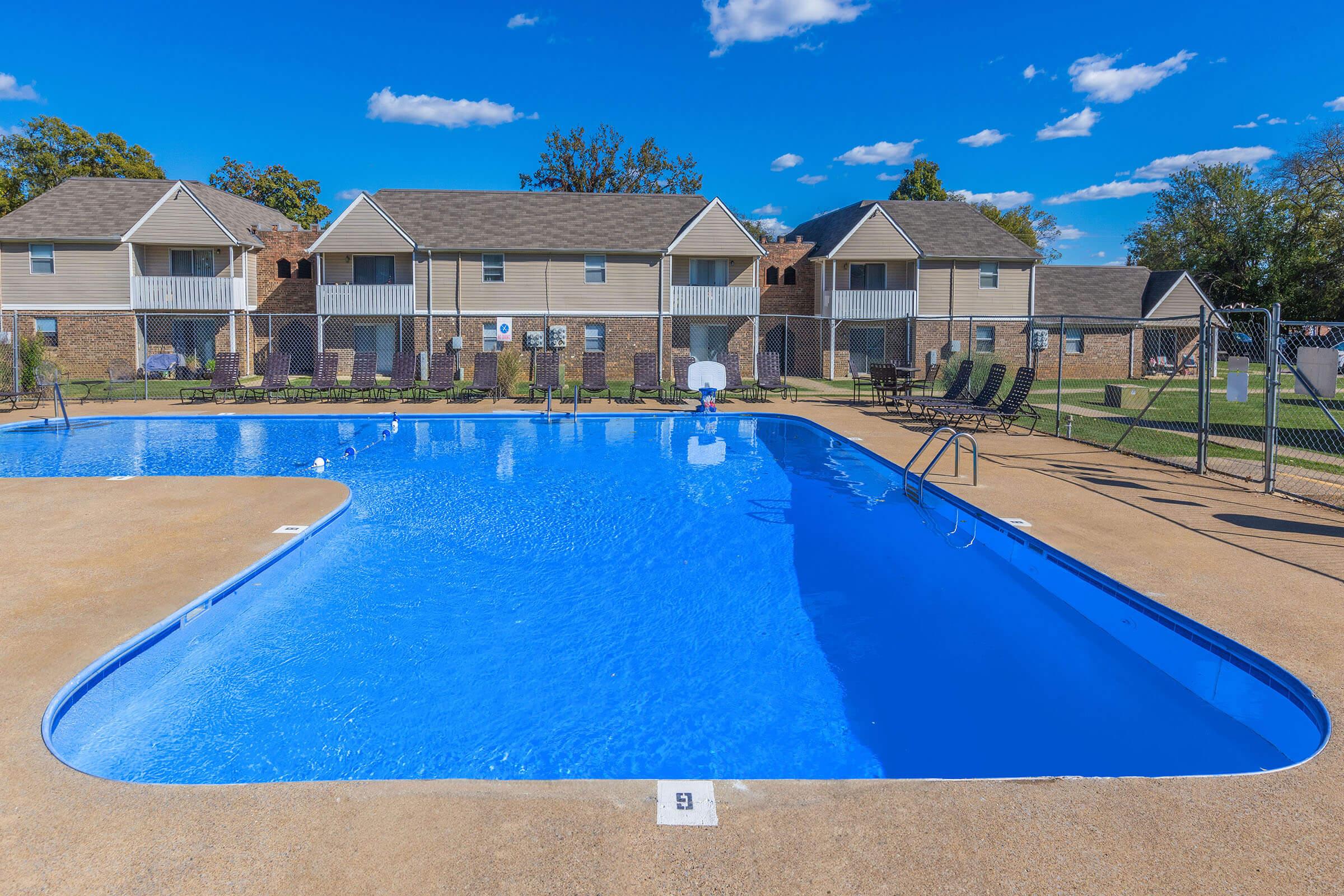 a house with a pool in front of a building