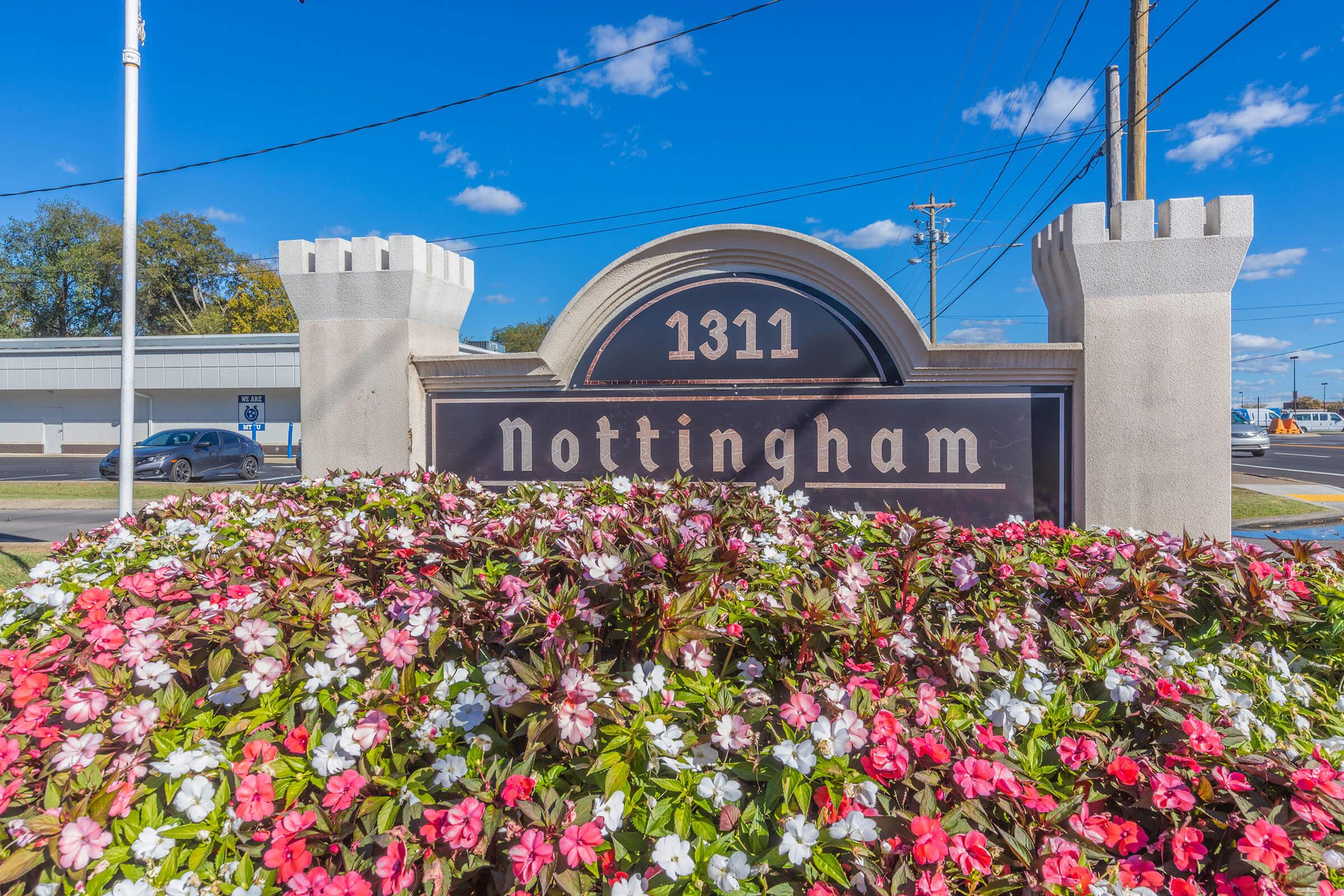 a close up of a flower garden in front of a building