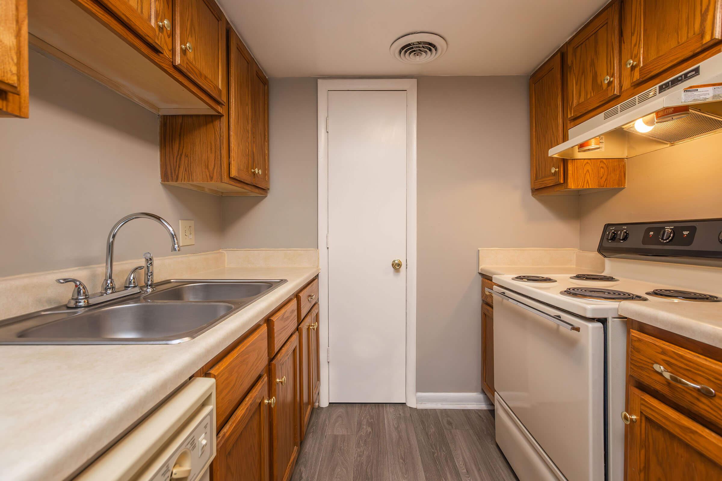 a kitchen with a stove and a sink