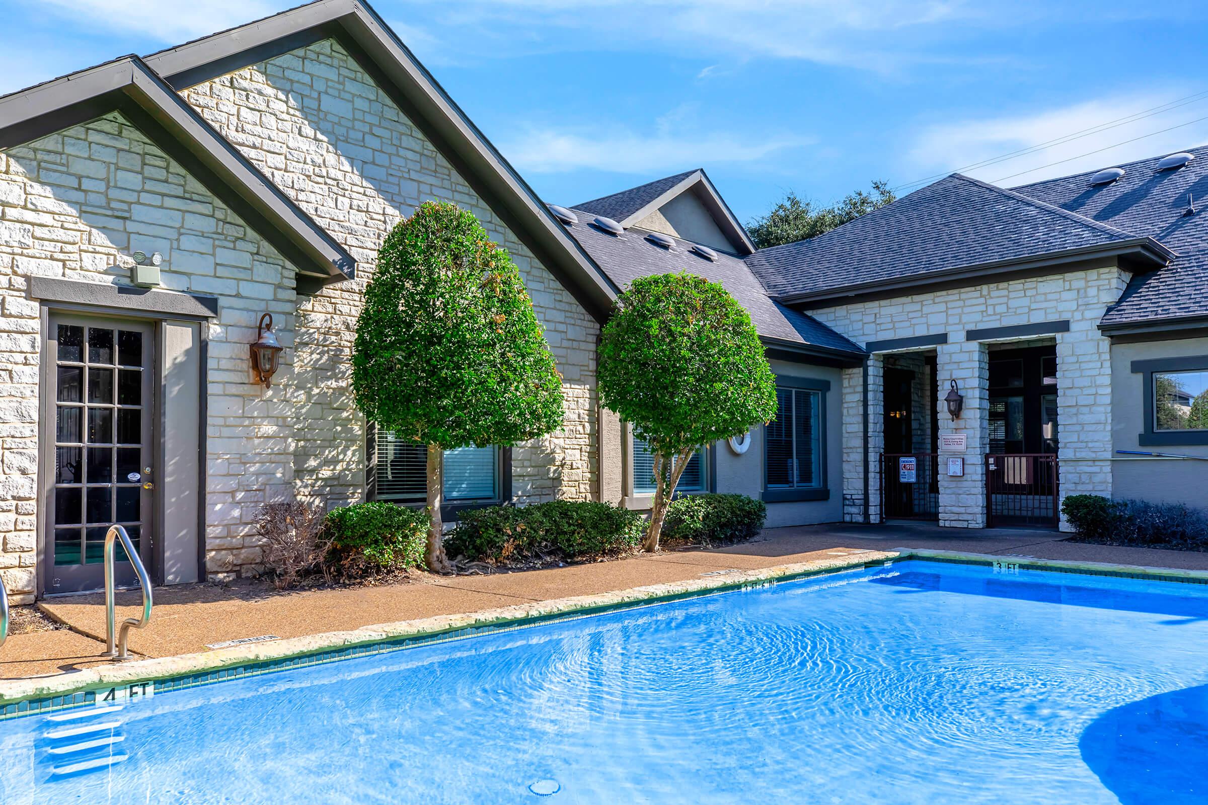 a person in a pool of water in front of a house