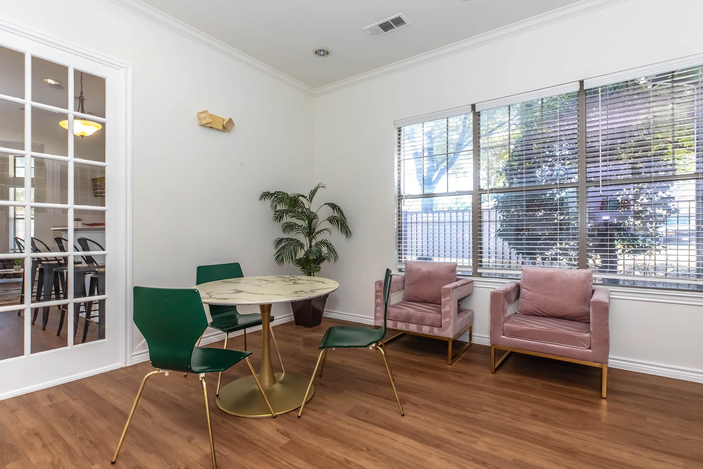 a living room filled with furniture and a large window