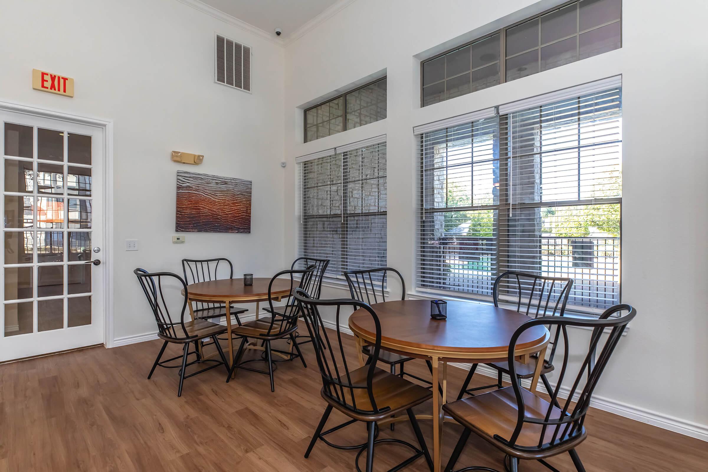 a dining room table in front of a window