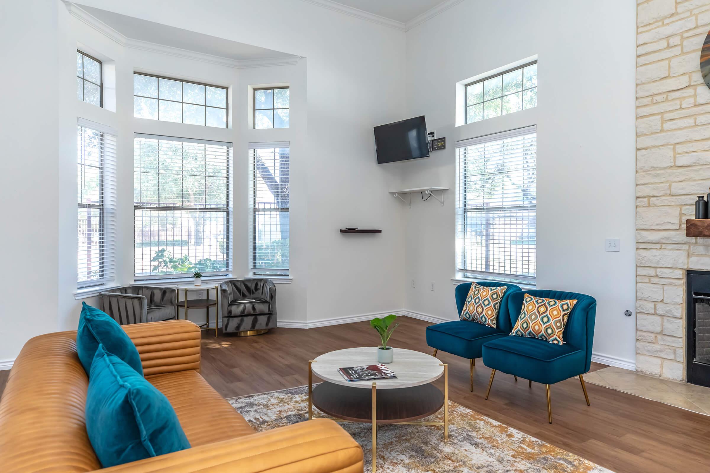 a living room filled with furniture and a large window