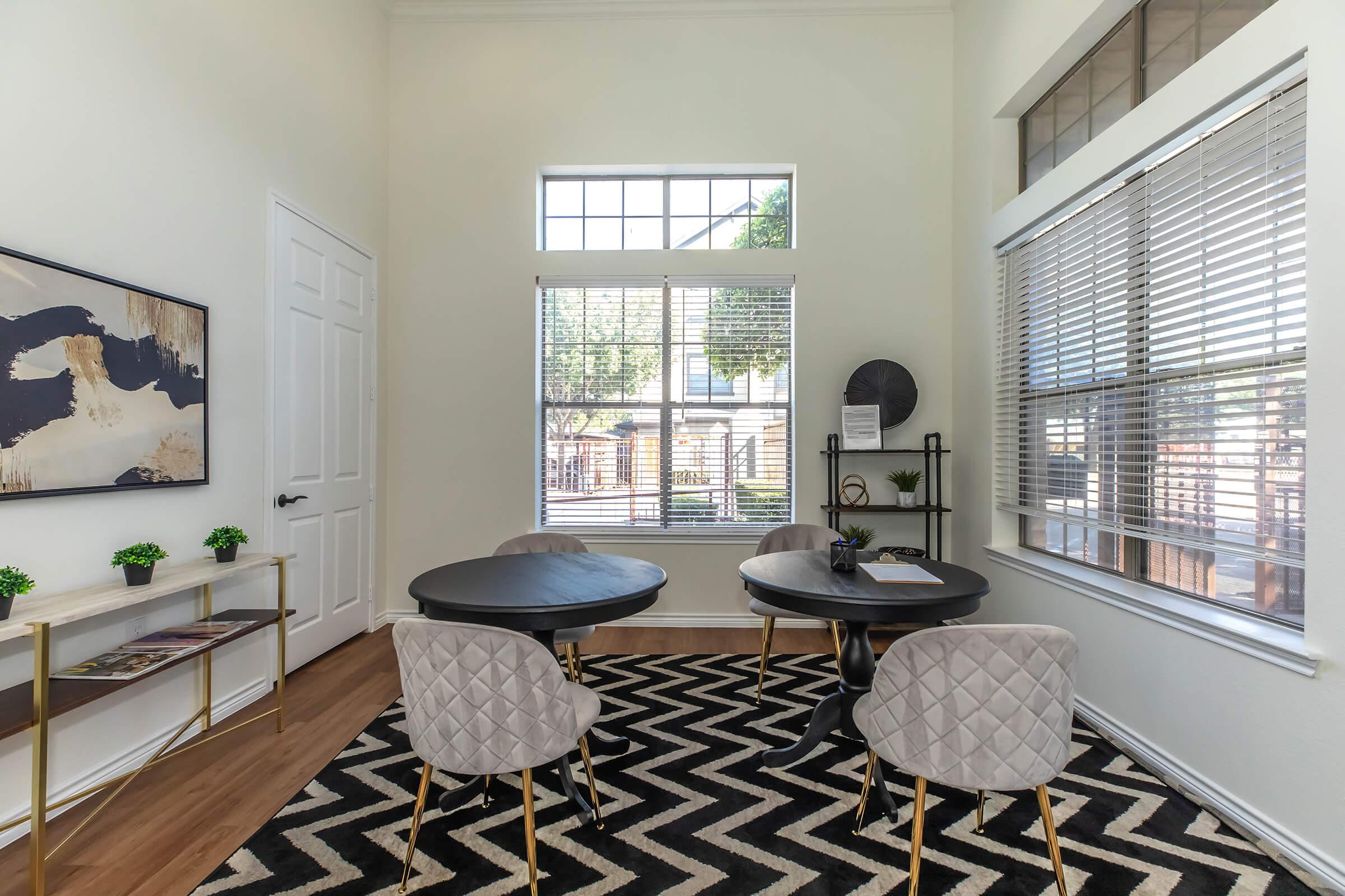 a living room filled with furniture and a large window