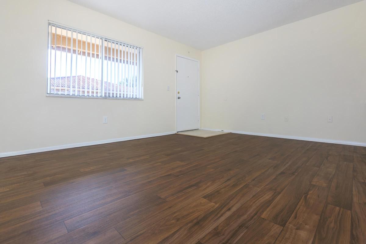 a large empty room with a wood floor