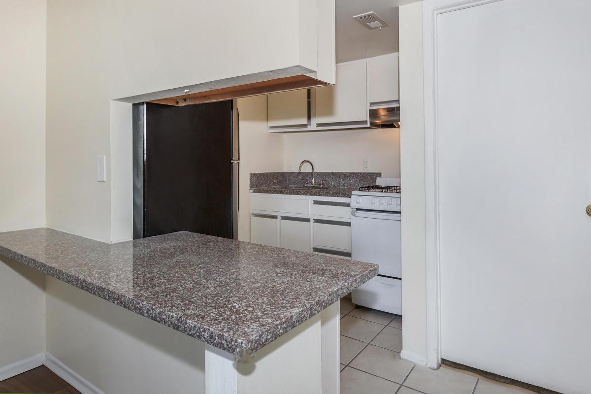 a kitchen with a sink and a mirror