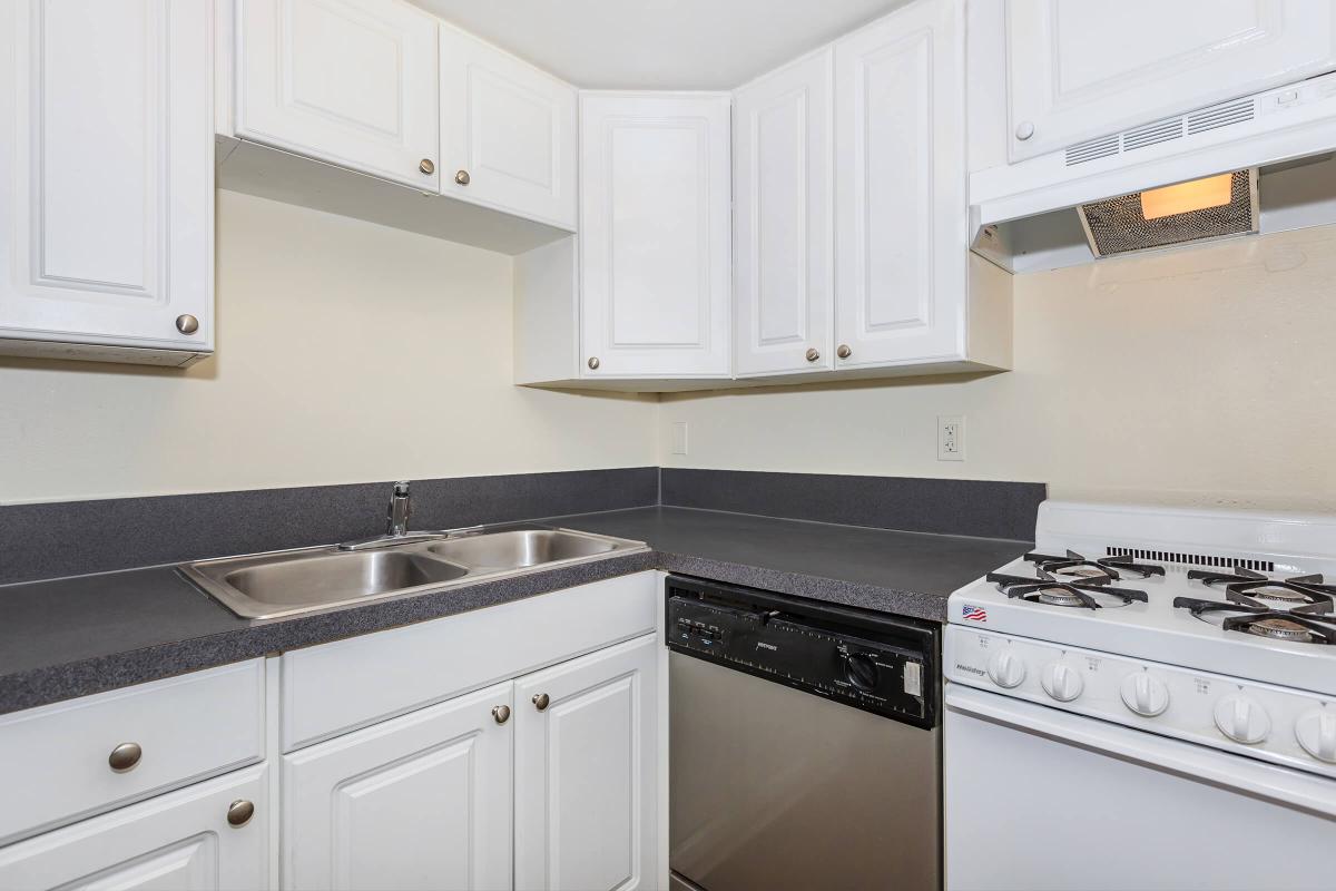 a stove top oven sitting inside of a kitchen