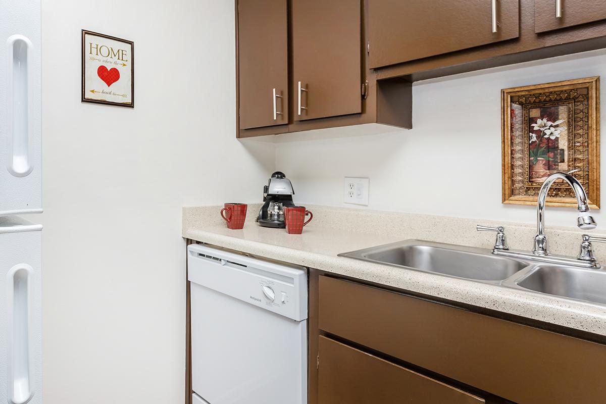 a kitchen with a sink and a mirror