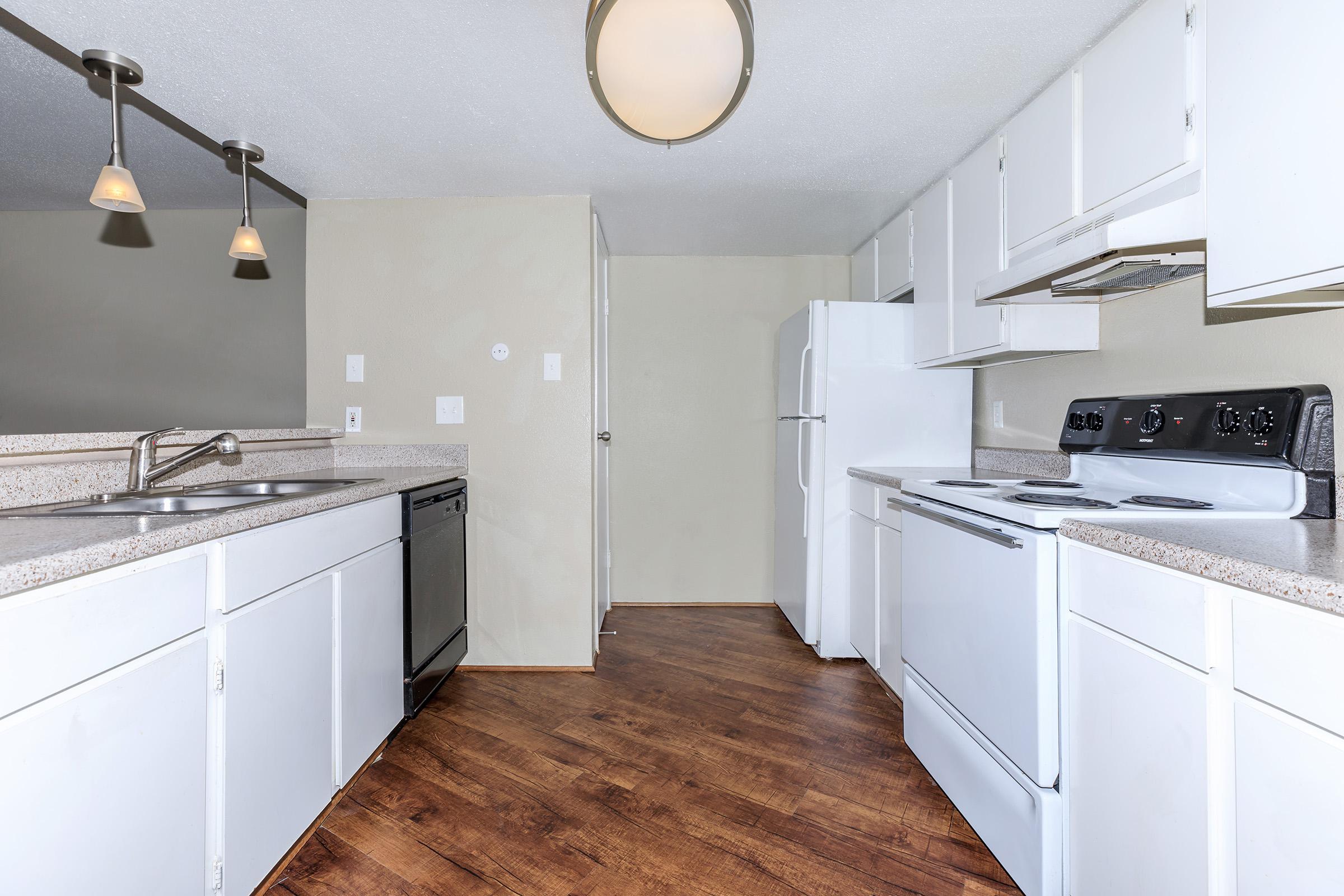 a large kitchen with white cabinets