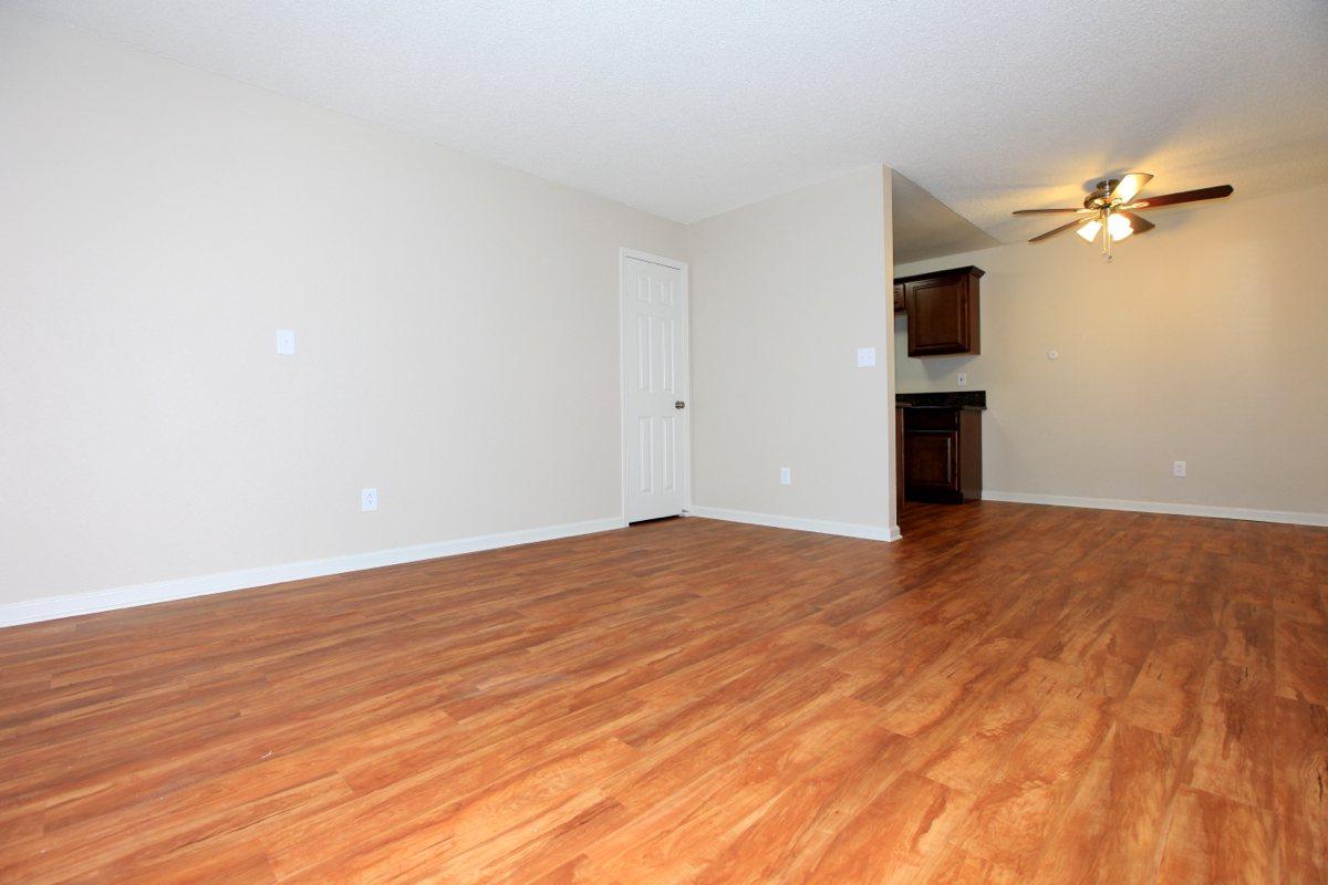 a large empty room with a wood floor