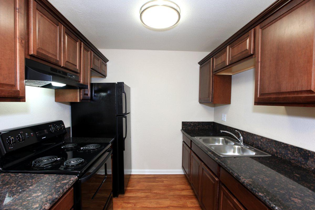 a modern kitchen with stainless steel appliances and wooden cabinets