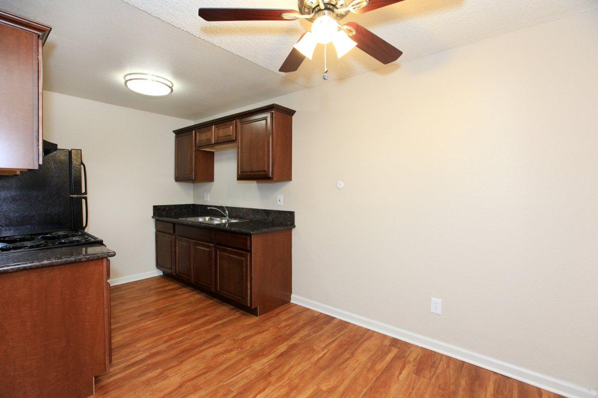 a kitchen with hard wood floors