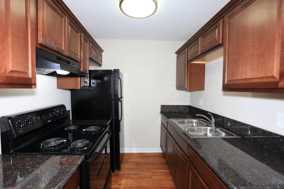 a modern kitchen with stainless steel appliances and wooden cabinets