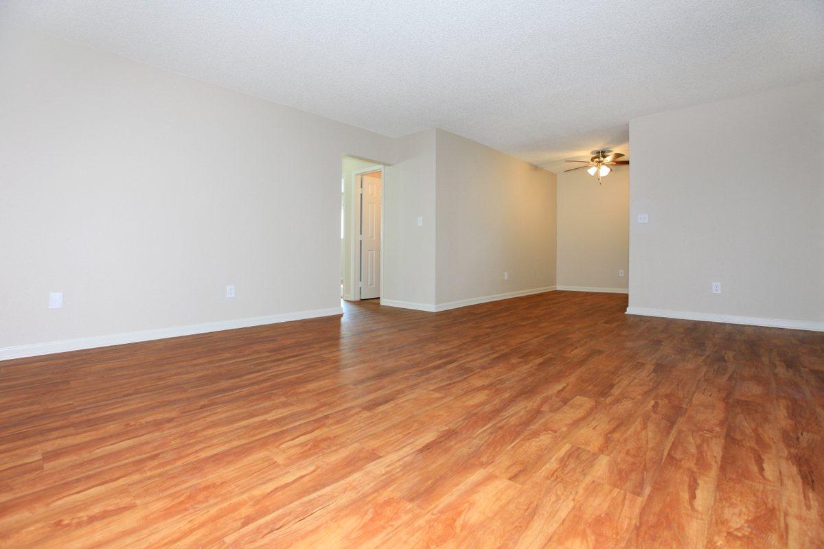 a large empty room with a wood floor