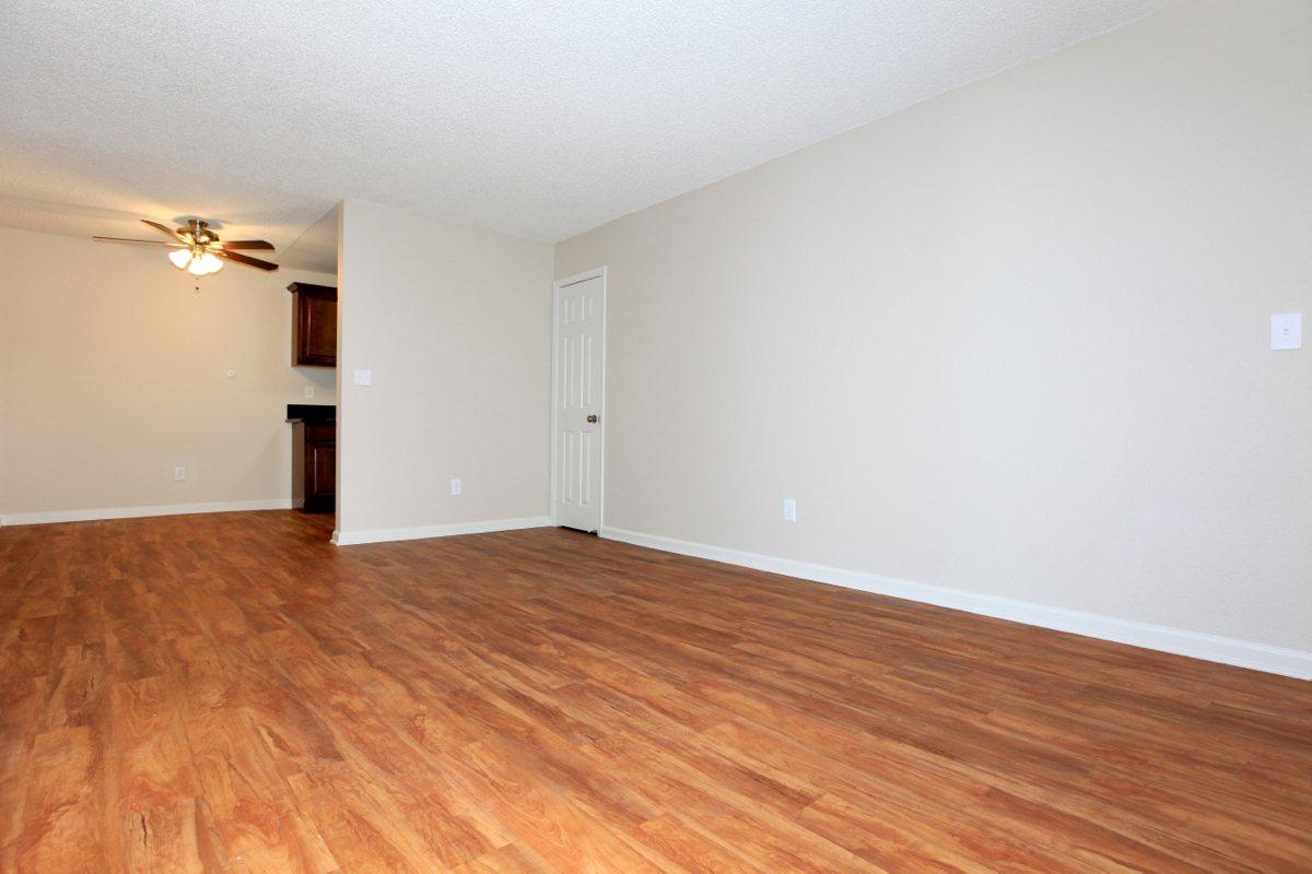 a large empty room with a hard wood floor