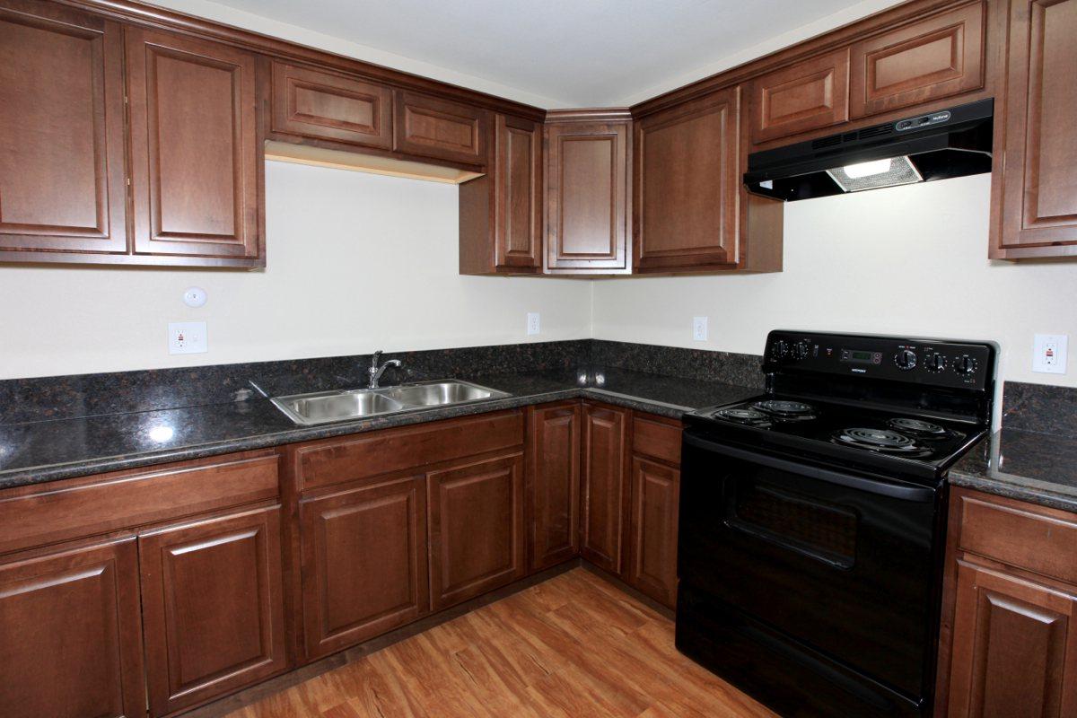 a kitchen with stainless steel appliances and wooden cabinets