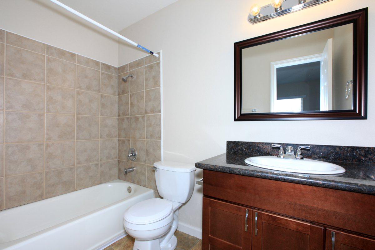 a large white tub sitting next to a sink