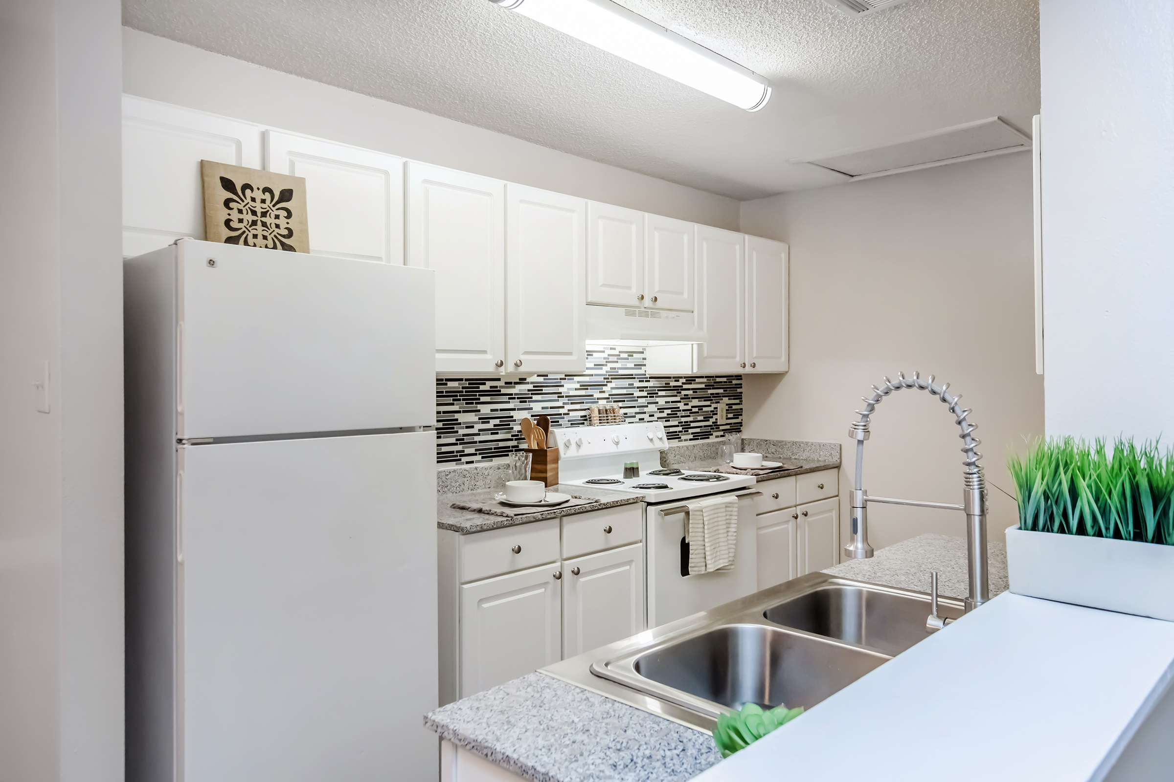 a kitchen with a sink and a refrigerator