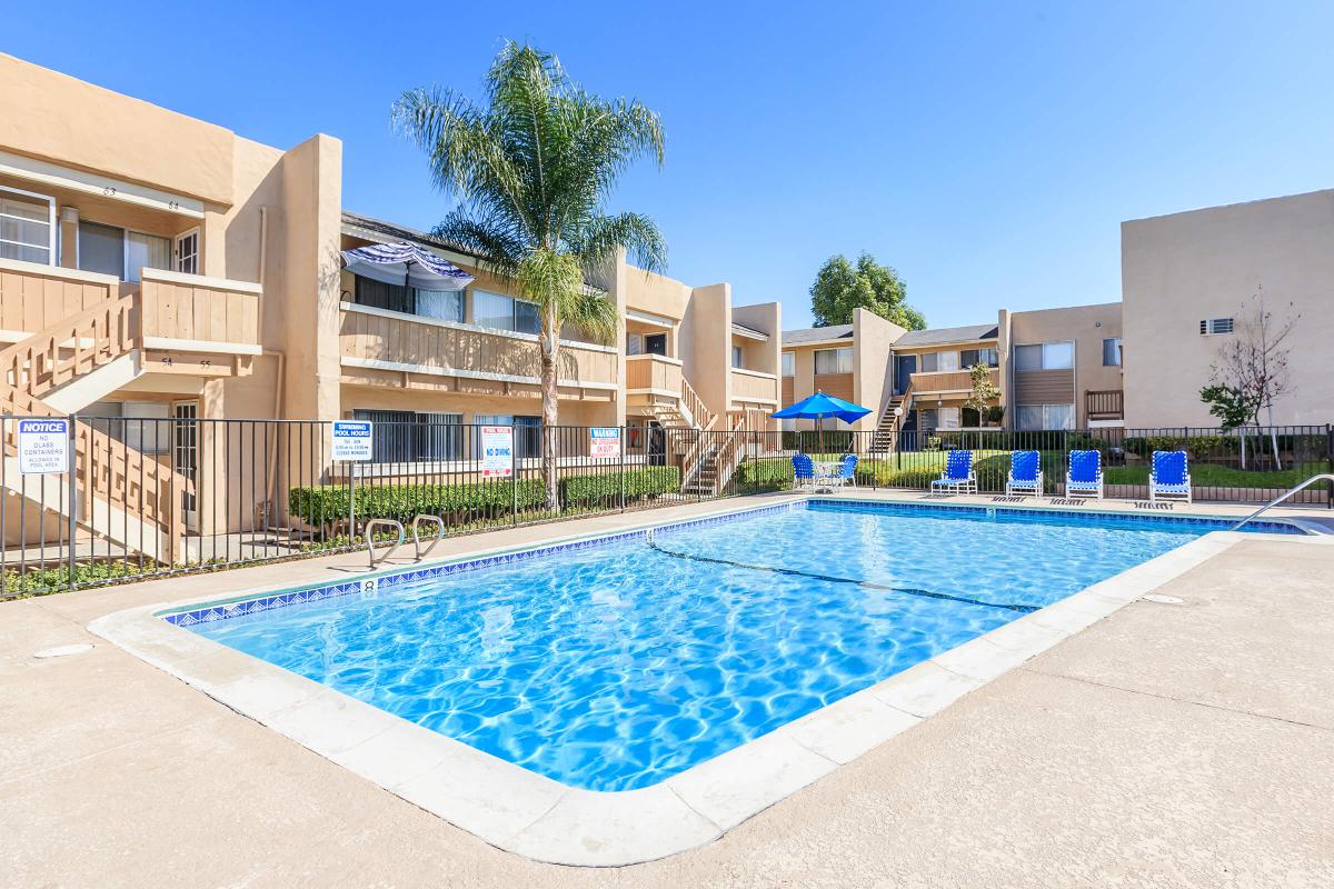 a house with a pool in front of a building