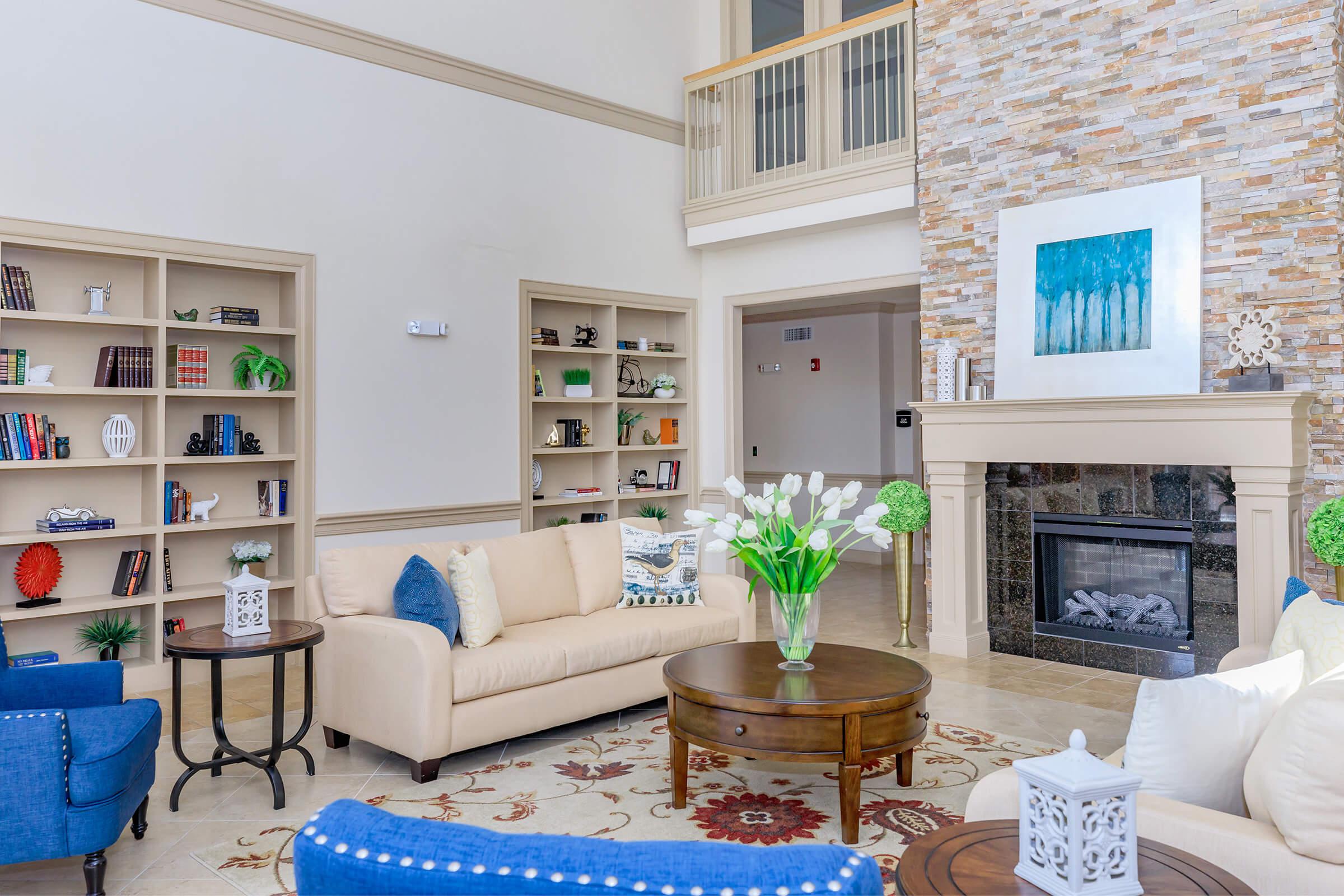 a living room filled with furniture and a fire place