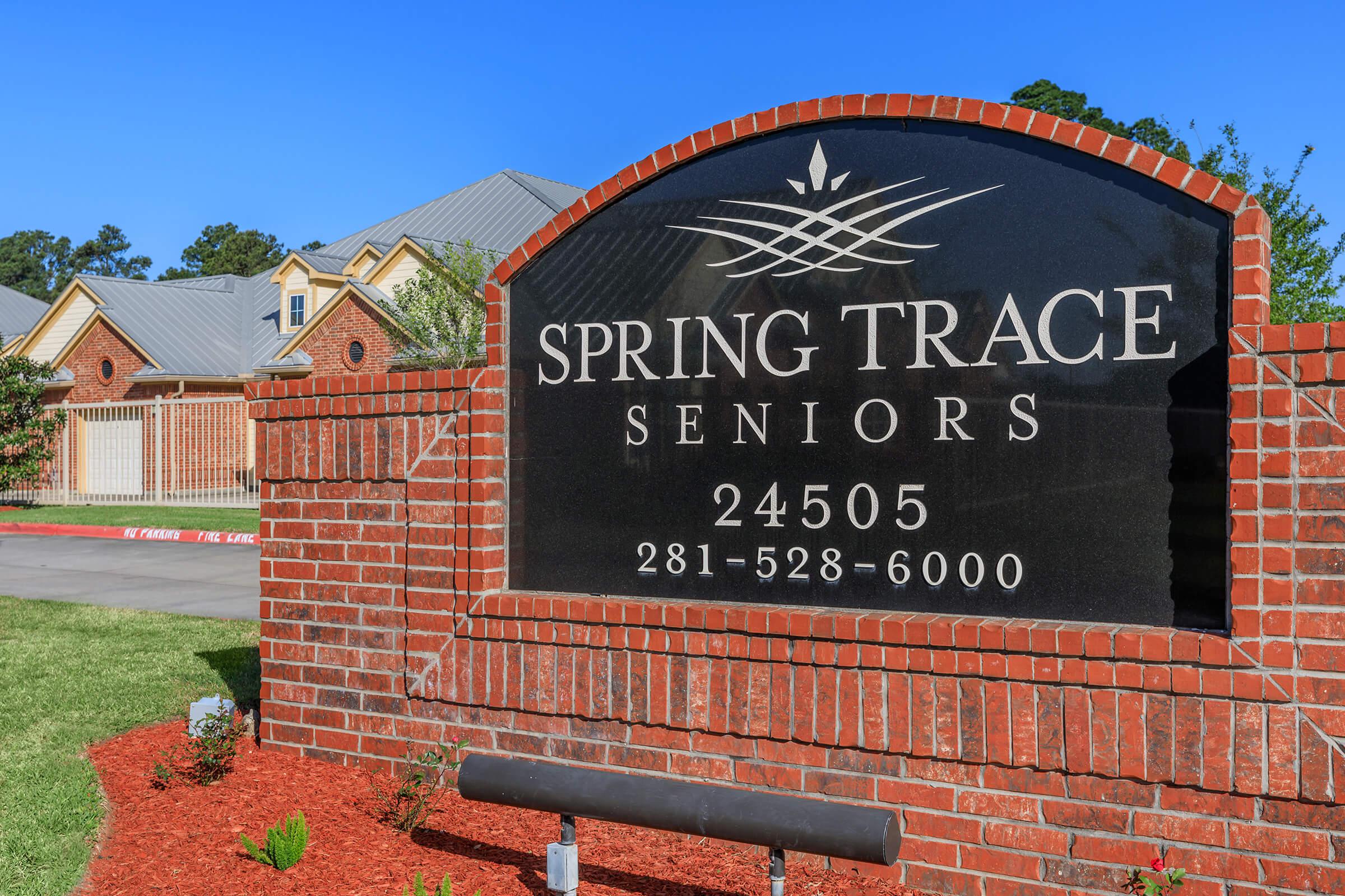 a sign in front of a brick building