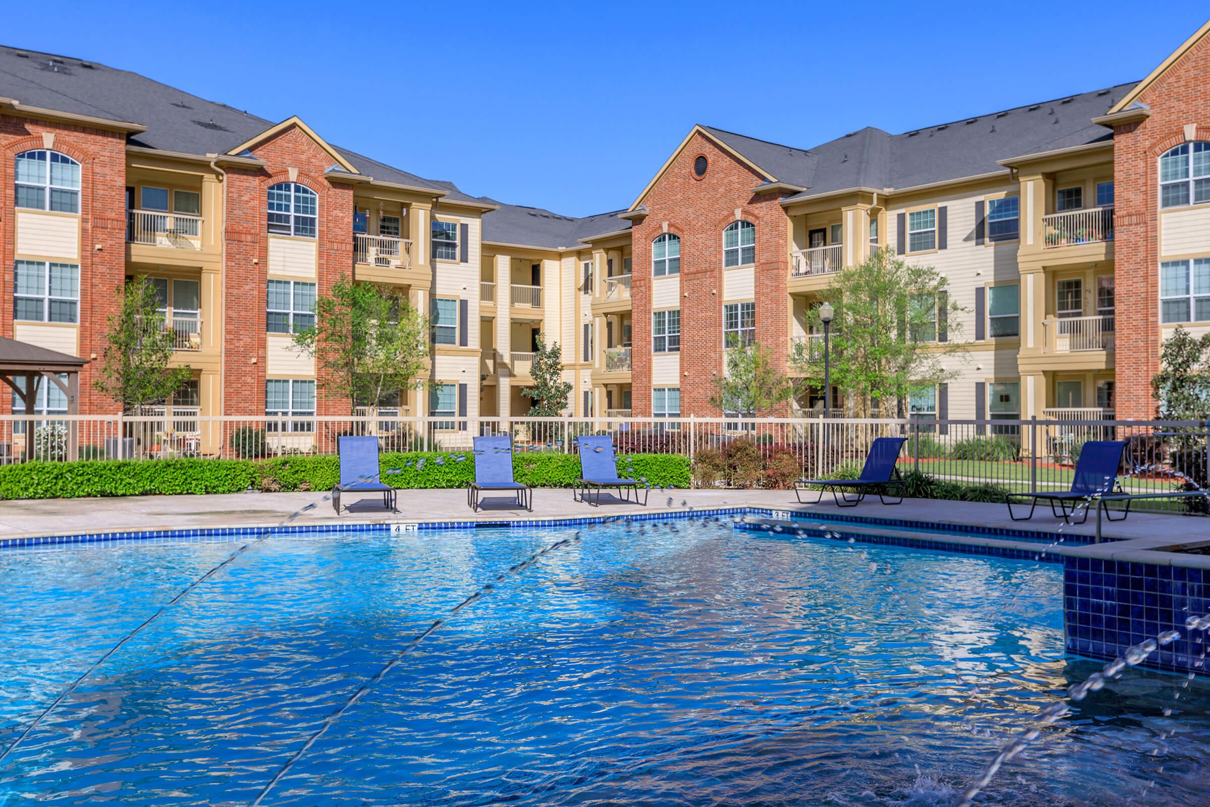 a blue pool of water in front of a house