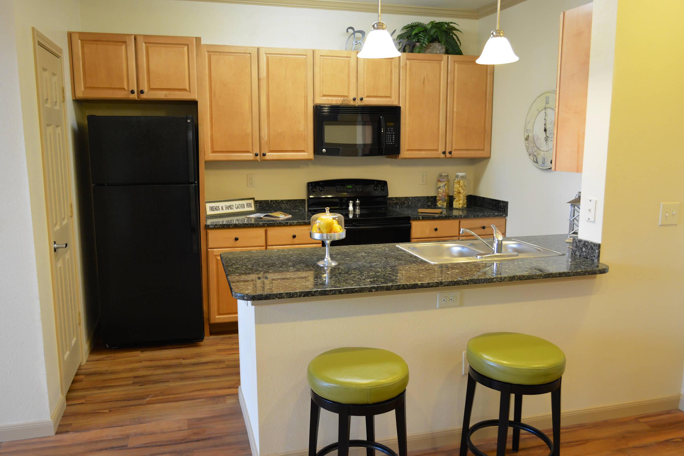 a stove top oven sitting inside of a kitchen