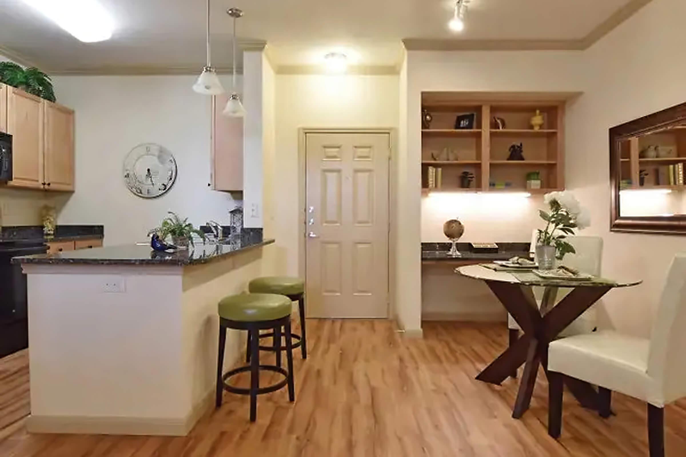 a living room filled with furniture on top of a hard wood floor