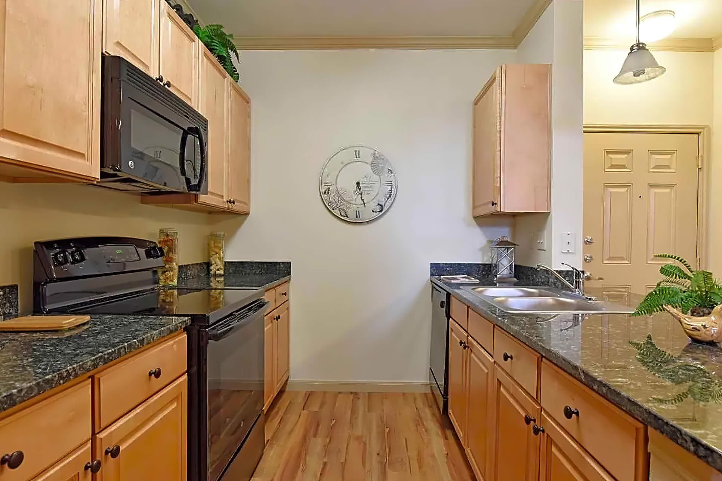 a kitchen with stainless steel appliances and wooden cabinets