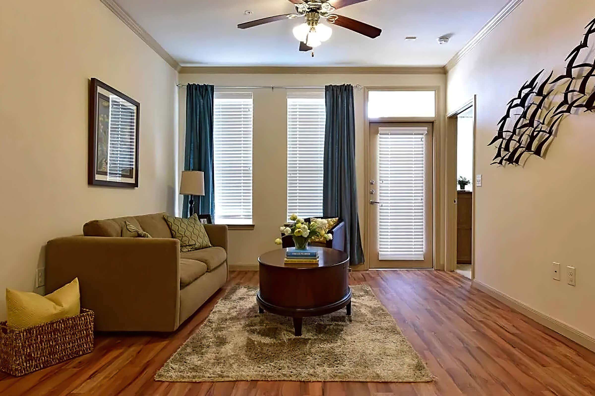 a living room filled with furniture and a large window