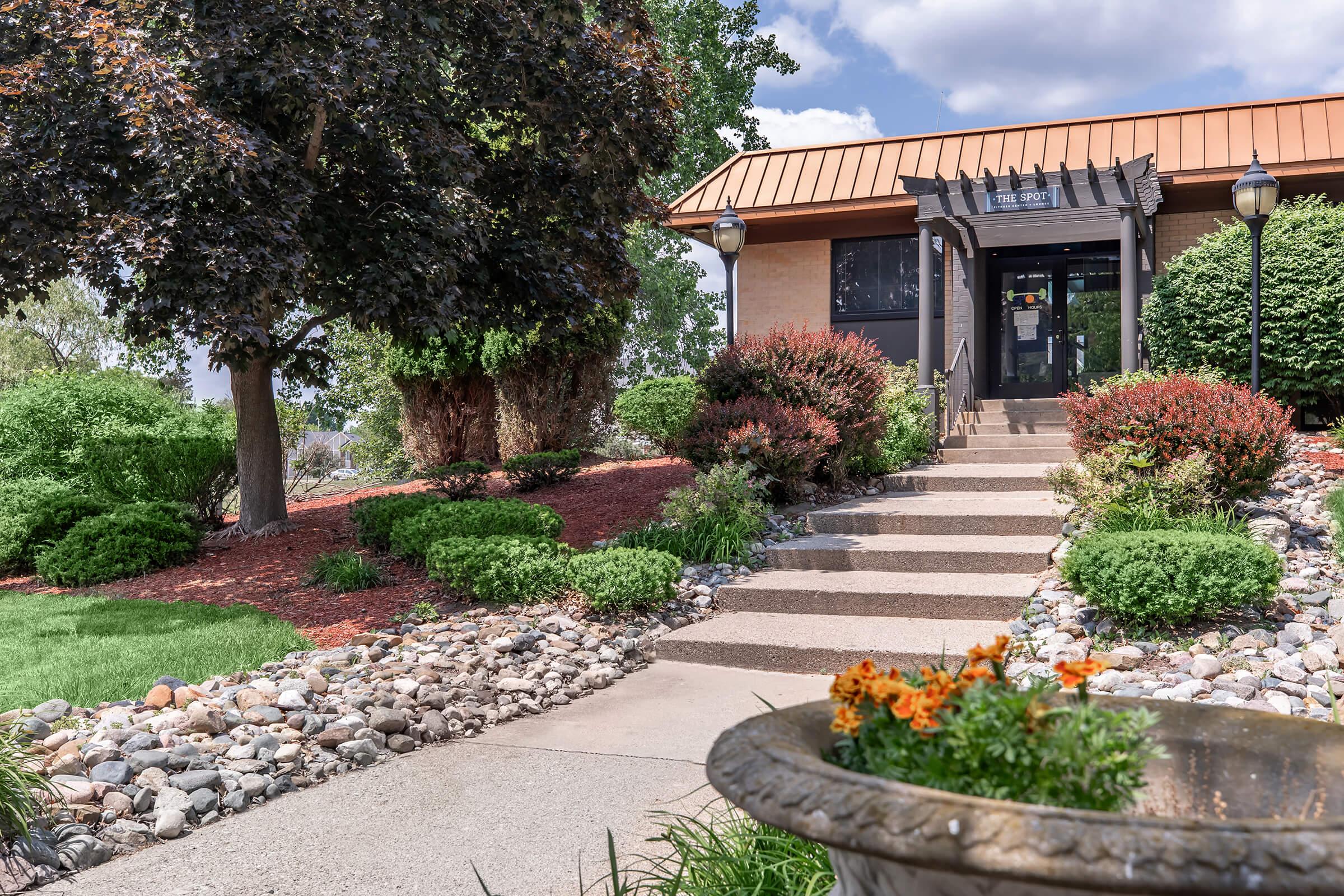 a close up of a flower garden in front of a building