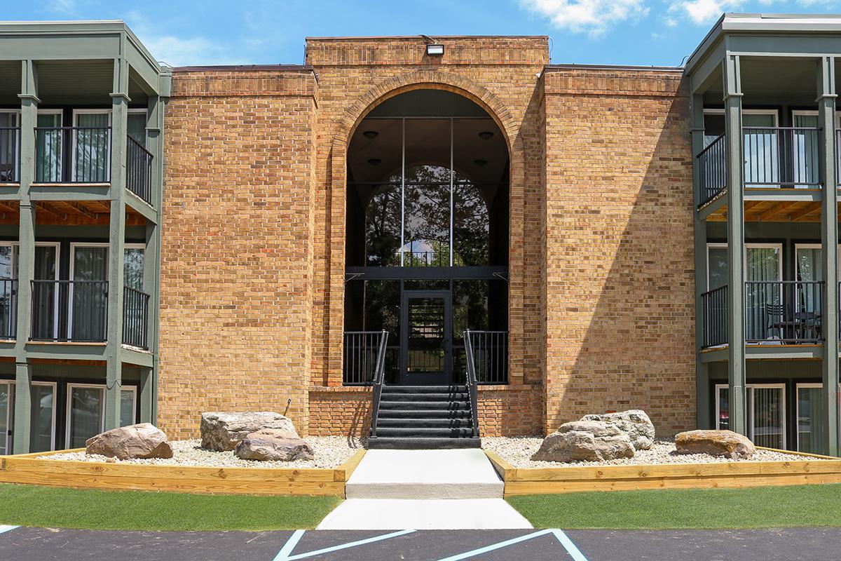 a large lawn in front of a brick building