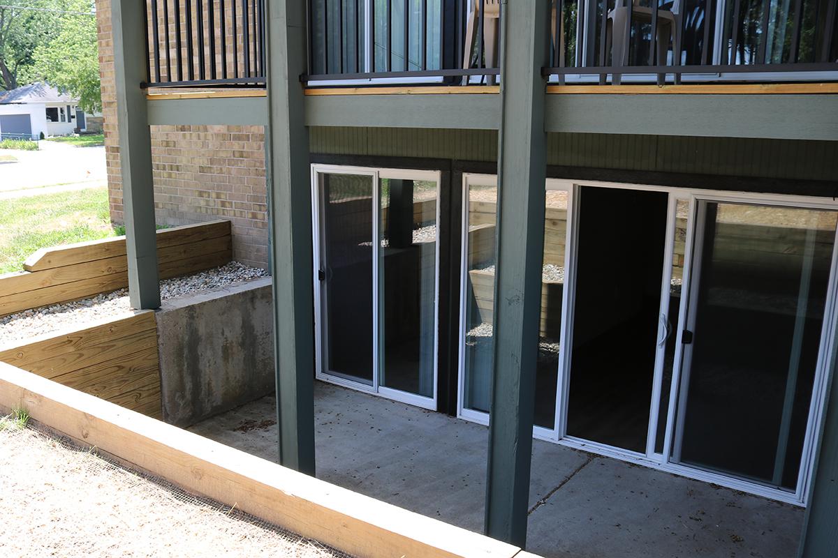 a close up of an empty sidewalk in front of a window