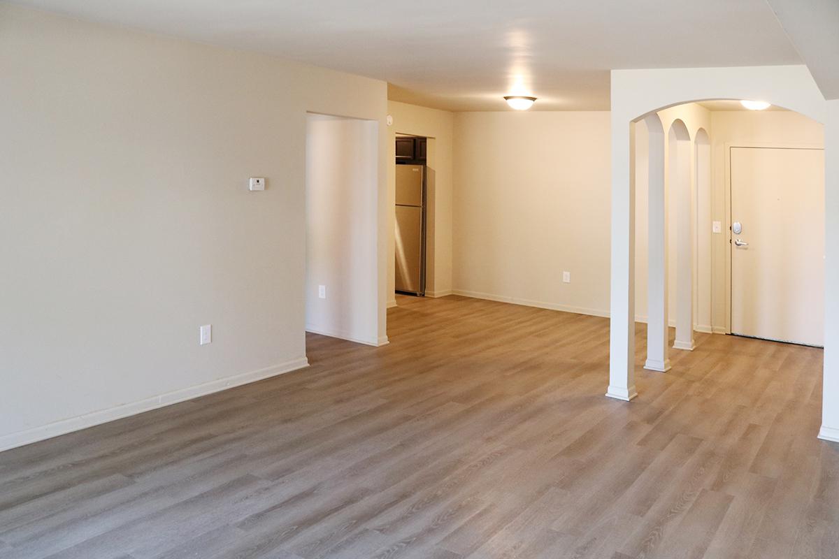 a large empty room with a wood floor